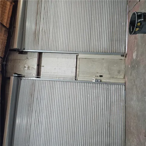 Industrial roll-up doors secure the spacious workshop area.