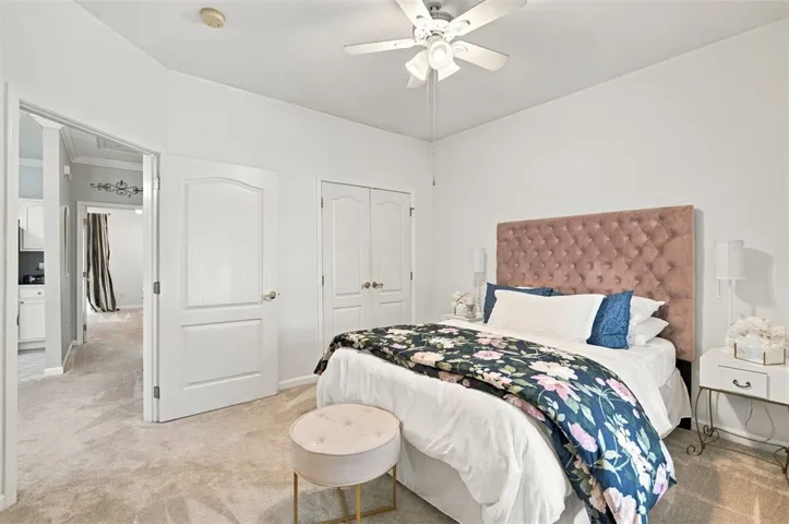 Soft carpeting pairs with classic six-panel doors in this comfortable sleeping space.