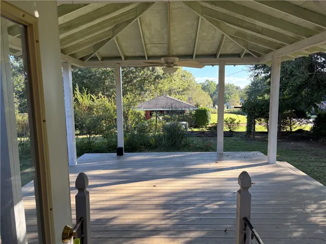 A spacious covered deck opens to a beautiful back yard.