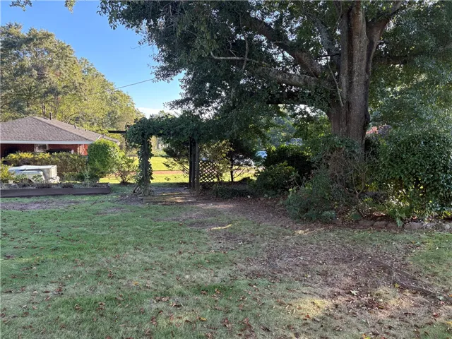Mature shade trees and a charming garden trellis