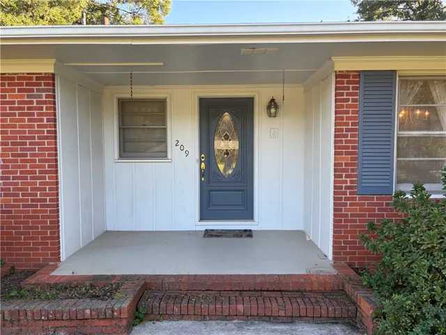 A welcoming front porch framed by brick accents