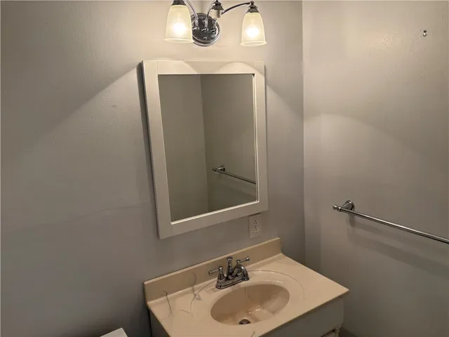 Primary bathroom with attractive vanity & decorative mirror