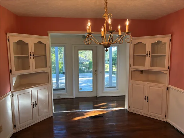 Versatile living space for dining or living room w/built-ins.