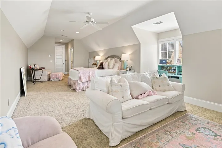Sloped ceilings and plush carpeting define this spacious upstairs retreat with a window alcove.