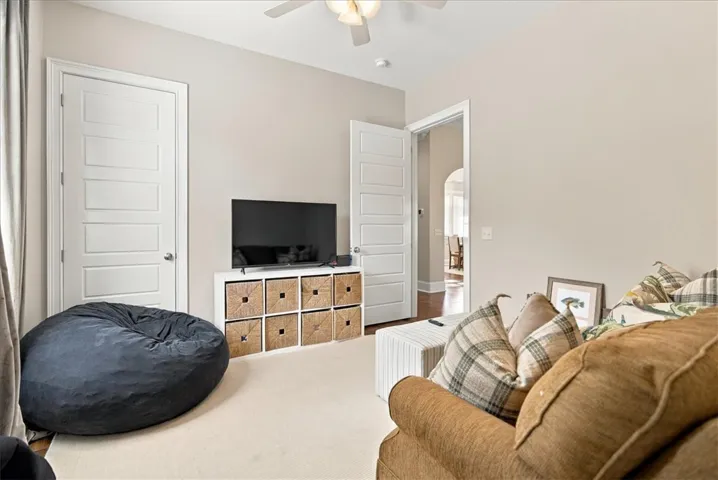 Smooth carpeting and classic paneled doors define this comfortable secondary living space.