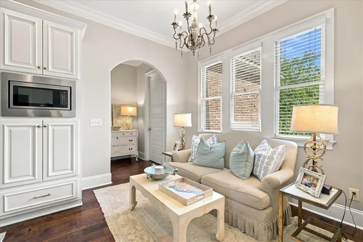 An arched doorway leads to the adjoining room, complemented by warm wood flooring.