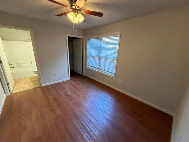 Rich wood floors and abundant natural light define this versatile bedroom with an attached bath.