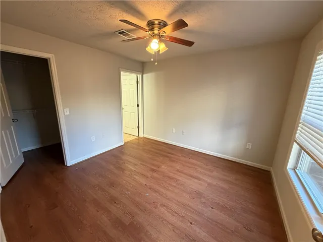 Gleaming hardwood floors and a functional layout define this comfortable bedroom space.