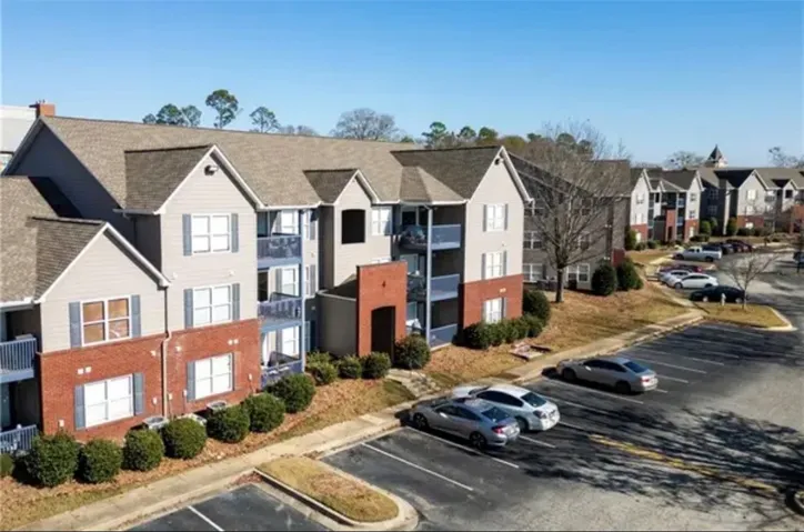 Multi-story residential buildings present classic brick accents and convenient on-site parking.