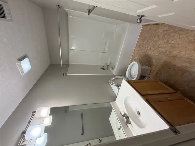 Functional bathroom layout complete with a classic tub and shower combination.