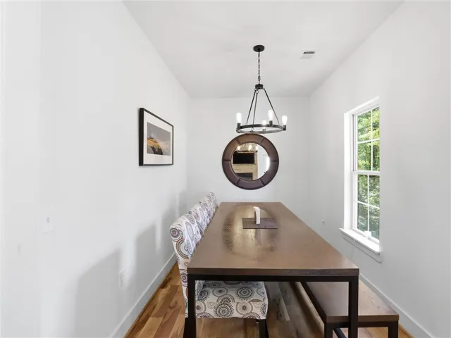 Rich hardwood floors and a classic window frame this inviting formal dining space.
