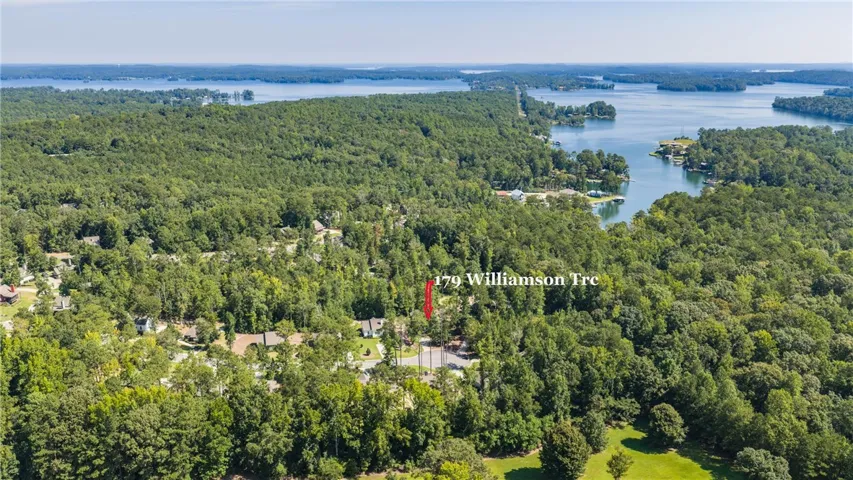 Lush woodlands surround this scenic peninsula property offering exceptional privacy and distant water views.