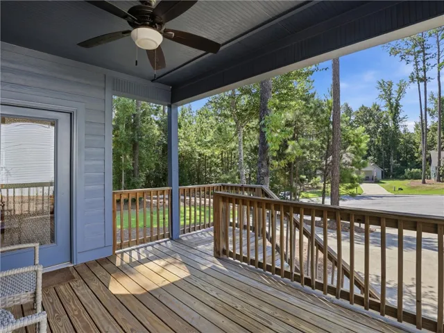 Sheltered outdoor living space overlooking the wooded yard offers a tranquil retreat.