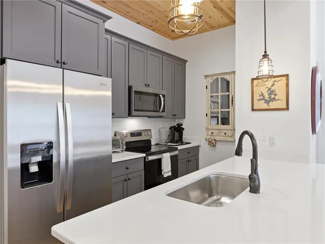 Gleaming stone countertops and sleek cabinetry define this modern culinary space.