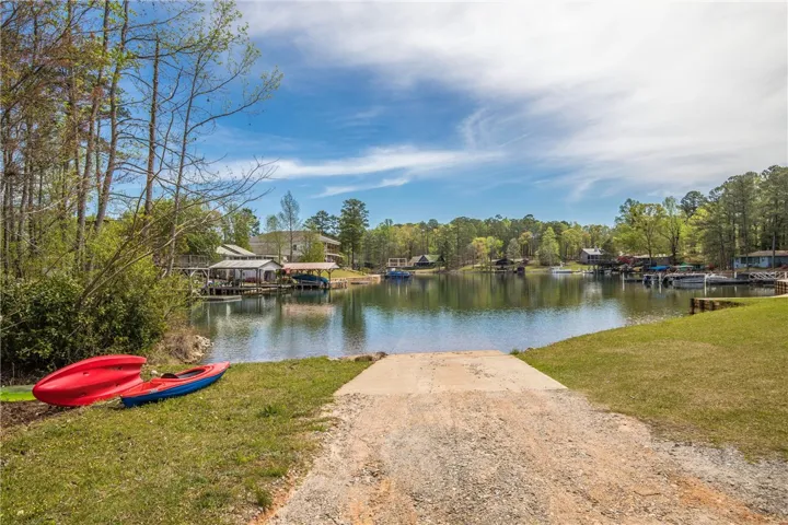 A private boat ramp leads directly into the calm waters of the lake.