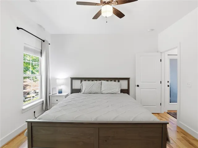 Gleaming hardwood floors run throughout this comfortable, sunlit bedroom space.