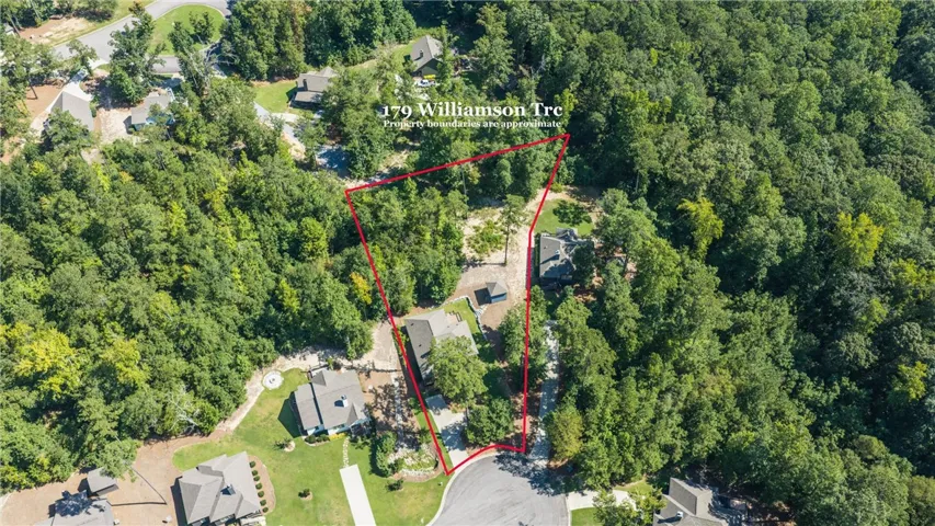 Lush mature trees surround this wooded property situated along a quiet cul-de-sac.