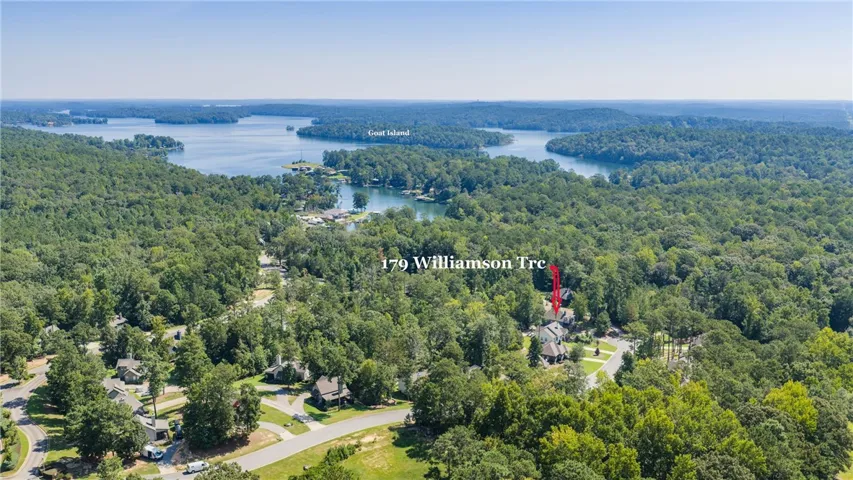 Lush forested hills surround a quiet neighborhood situated near the scenic waterfront.