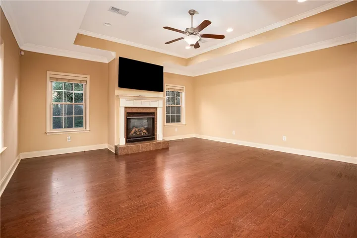 Rich hardwood floors and a classic fireplace define this welcoming living space.