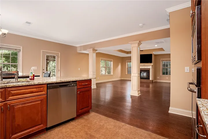 Gleaming hardwood floors flow from the open kitchen into a spacious family room with fireplace.