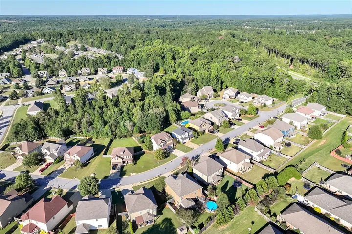 Lush green trees surround this peaceful suburban neighborhood of single-family homes.