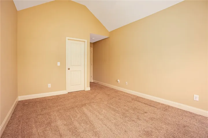 Vaulted ceilings soar over plush carpeting in this versatile interior space.