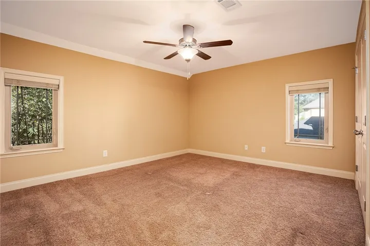 Plush carpeting and classic crown molding define this versatile upper-level space.
