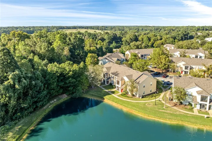 Lush woodland and a serene pond frame this multi-family residential community.