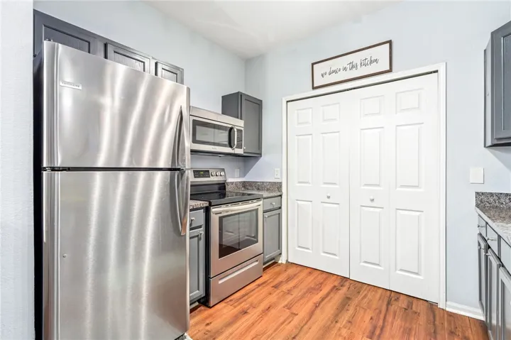 Gleaming hardwood floors and stone countertops anchor this classic kitchen design.