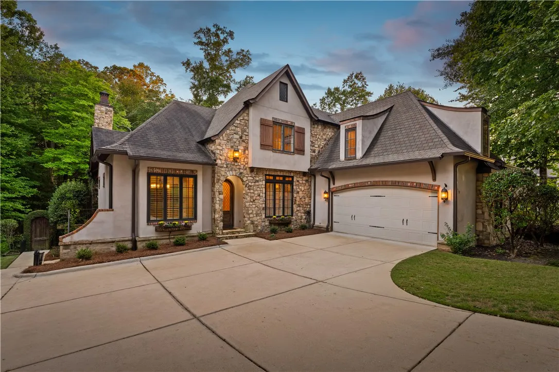 Stone accents and a sweeping driveway create an inviting approach to this elegant home.