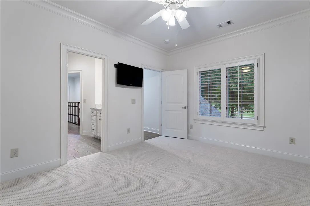 Upstairs. Plush carpeted flooring and detailed crown molding define this comfortable upper-level bedroom retreat.
