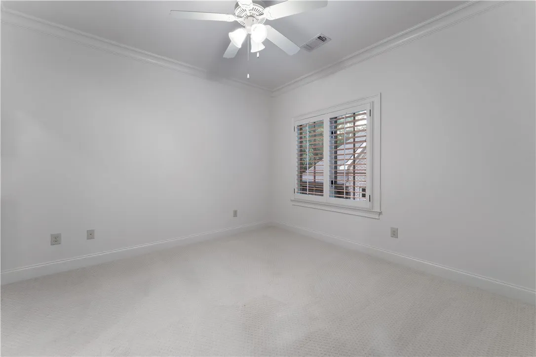 Upstairs. Crisp crown molding accents the clean-lined walls and soft carpeting of this serene space.