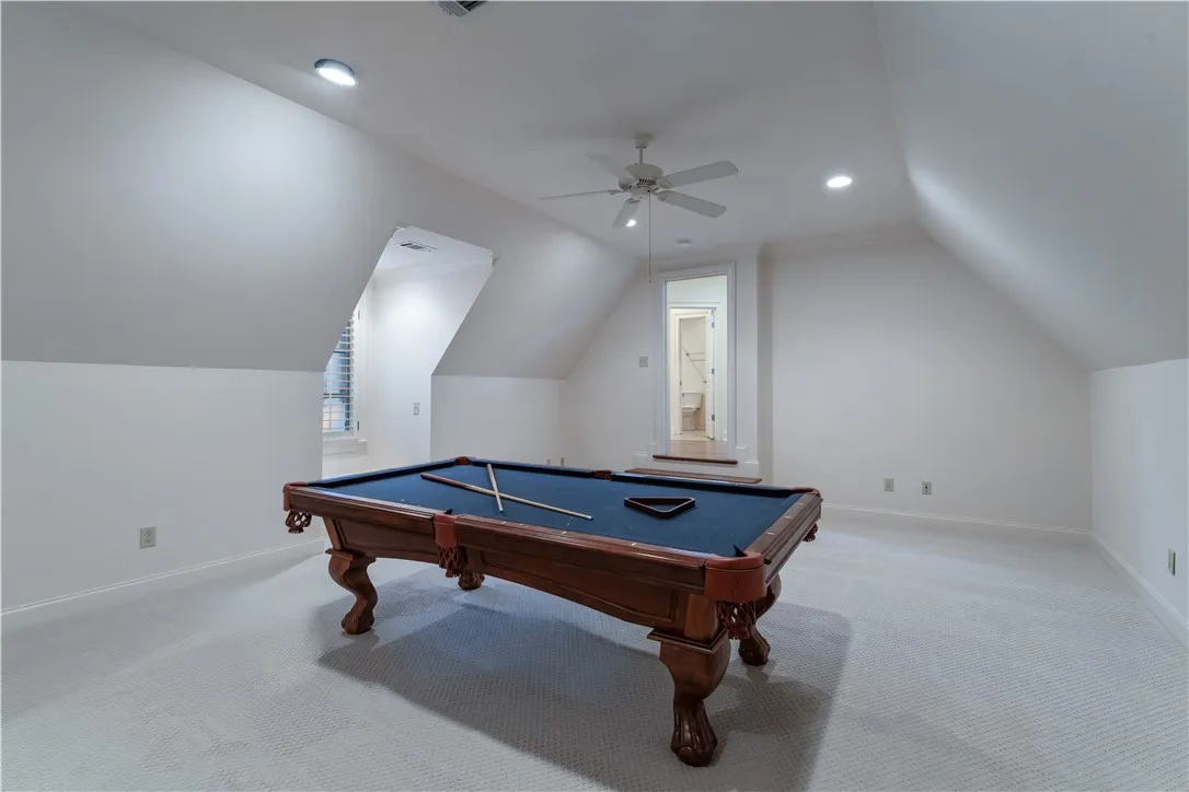 Upstairs. Angled ceilings and soft carpeting define this versatile upper-level recreation space.