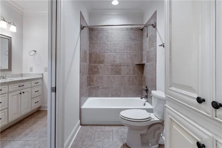 Upstairs. Tiled tub surround and crown molding define this classic guest bath layout.