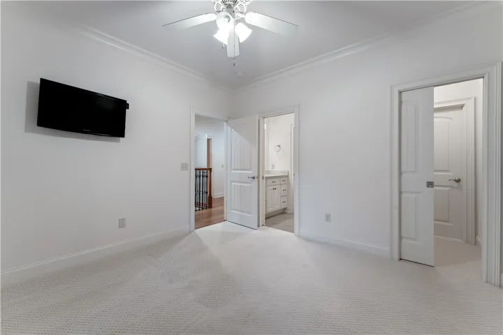 Upstairs. Plush carpeting and elegant crown molding define this versatile upper-level room.