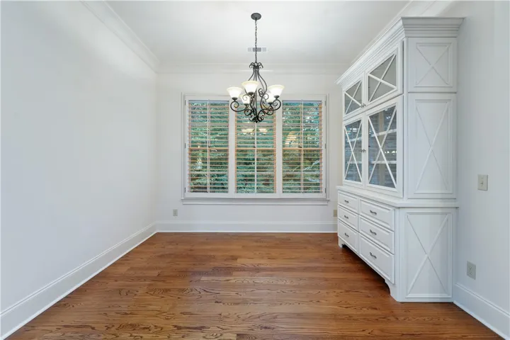Gleaming hardwood floors and a classic built-in hutch anchor this elegant dining space.