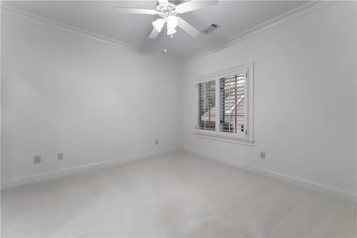 Upstairs. Crisp crown molding accents the clean-lined walls and soft carpeting of this serene space.