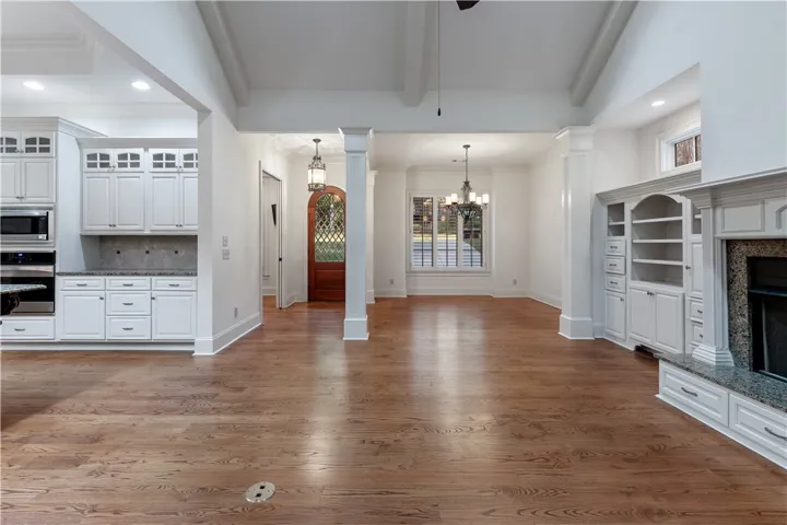 Gleaming hardwood floors and a brick fireplace highlight the open, airy flow of this level.