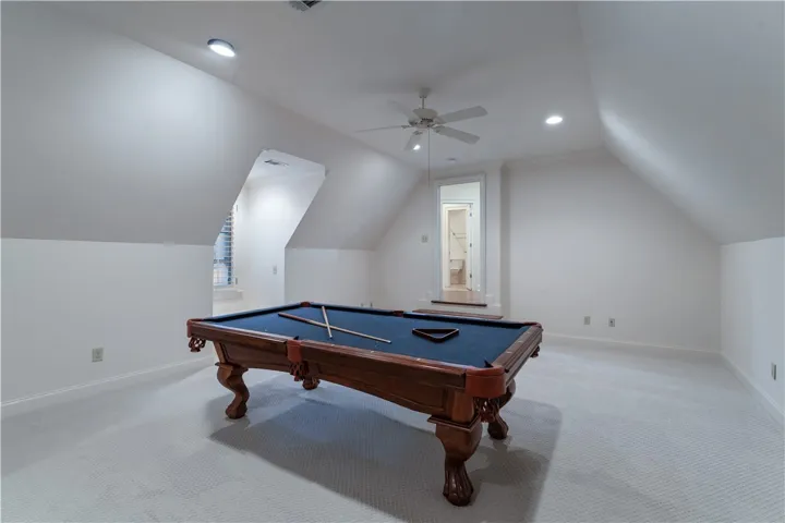 Upstairs. Angled ceilings and soft carpeting define this versatile upper-level recreation space.
