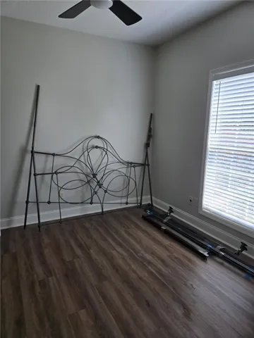 Rich wood-inspired floors and a large multi-pane window create a tranquil atmosphere.