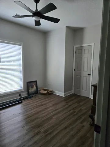 Rich wood floors and a clean layout frame this versatile bedroom space.
