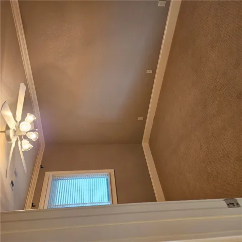 High ceilings highlighted by classic crown molding and soft carpet flooring define this room.