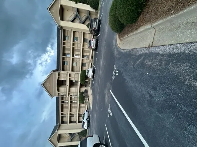 Assigned parking spaces sit directly in front of this multi-story residential building.