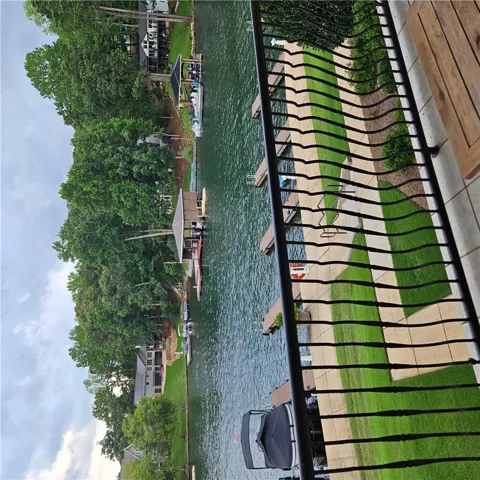 Metal balcony railings overlook peaceful canal waters lined with private boat slips.