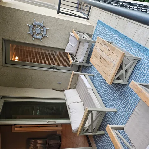 Tiled flooring and durable stucco walls define this private outdoor balcony retreat.