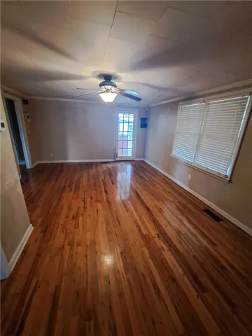 Polished hardwood floors and generous natural light define this versatile living space.