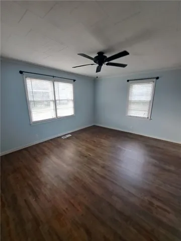 Gleaming hardwood floors and classic crown molding define this versatile living space.