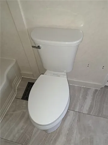 Polished tile flooring complements the clean design of this bathroom space.