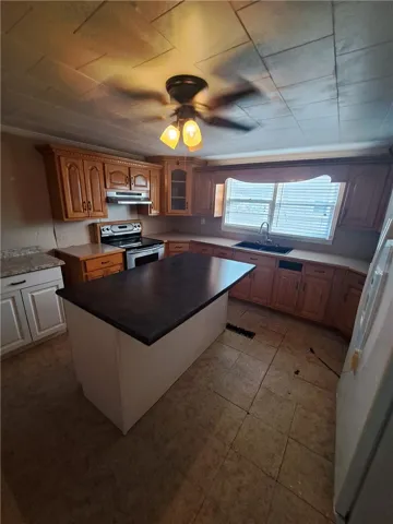 Oak cabinetry paired with tile flooring creates a classic footprint for your culinary endeavors.