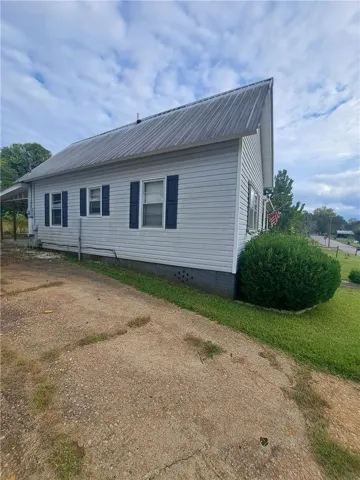 A durable metal roof and classic shutters highlight this low-maintenance exterior.